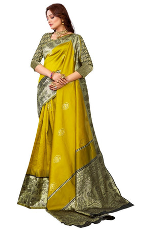 Woman wearing a yellow saree with green border on a white background