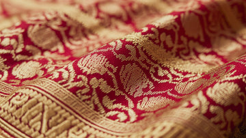 Close-up of Maharani Weaves Jacquard saree showing intricate golden and red woven patterns with detailed silk texture.