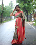 Woman in a traditional saree standing on a road with greenery in the background