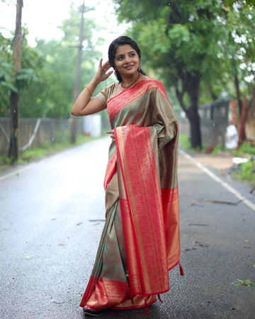 Woman in a traditional saree standing on a road with greenery in the background