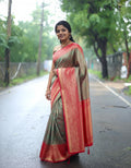 Woman in a traditional saree standing on a road with greenery in the background