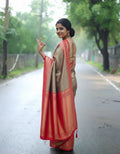 Woman in a traditional saree on a road with greenery in the background