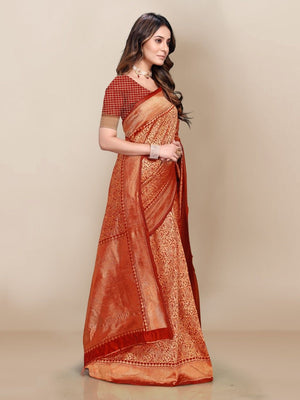Woman wearing a traditional orange saree with a plain background