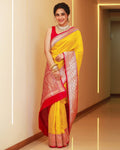 Woman wearing a yellow and red saree with a plain background