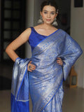 Woman wearing a blue saree with a blurred background