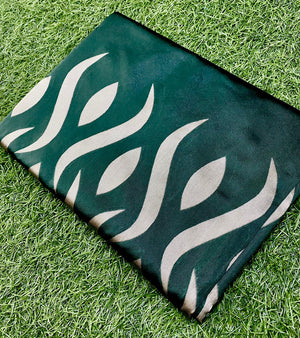 Green mat with white flame pattern on grass
