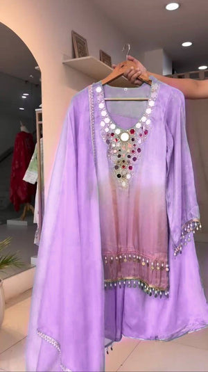 Purple dress with embellishments on a hanger in a store setting