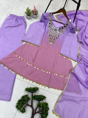 Purple traditional outfit with embellishments on a white floor.